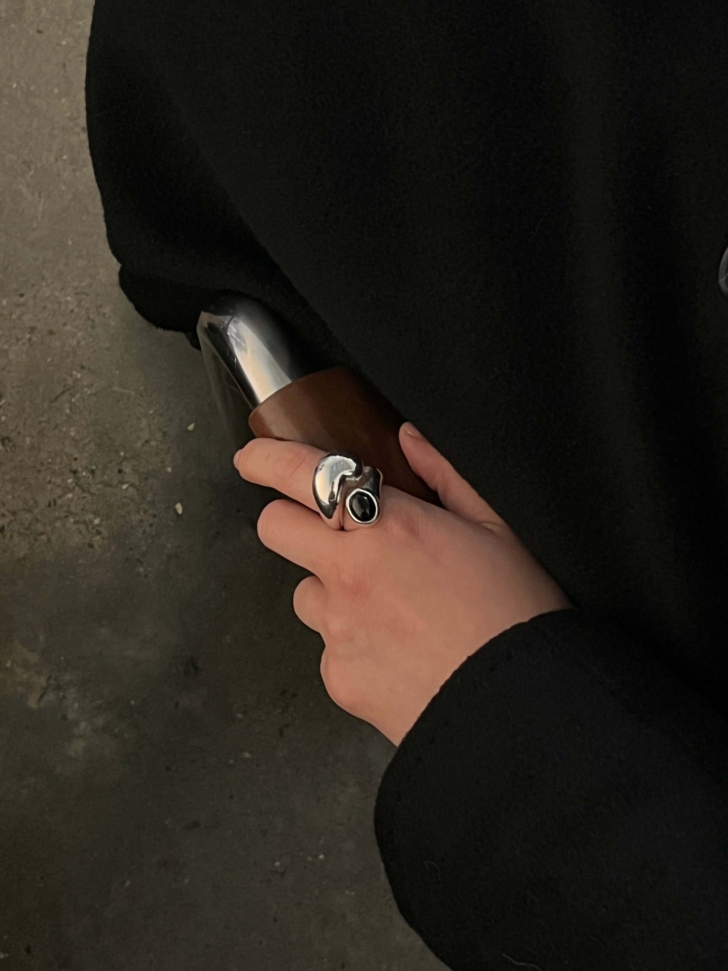 Handmade sculptural silver Eclipse ring, worn on a hand with smooth, polished surfaces creating a bold, circular design. This unique statement ring adds an artistic touch to any outfit, combining craftsmanship with modern style.