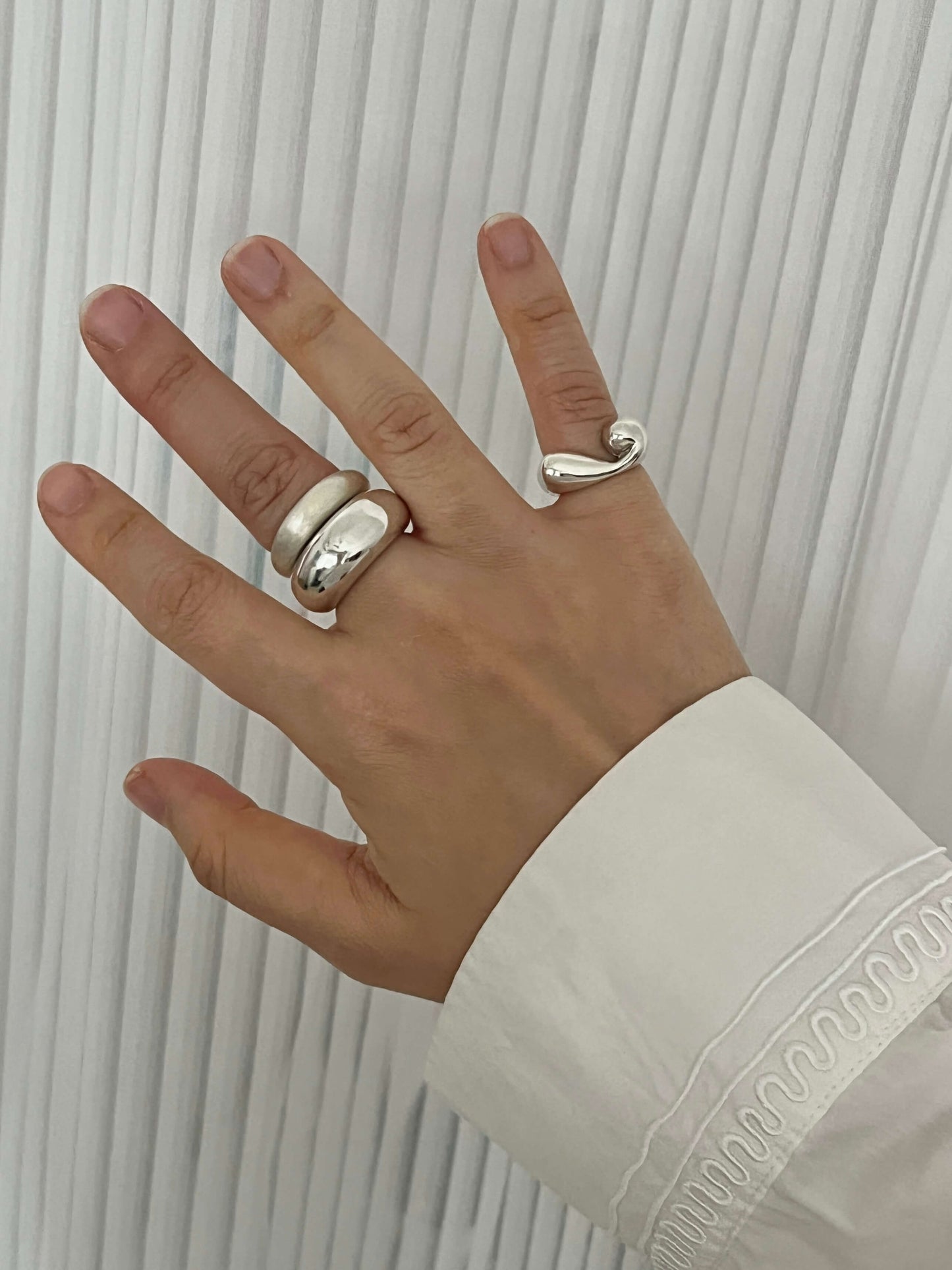 Everyday Duo sculptural sterling silver ring stack worn on hand, showcasing satin and mirror finishes. Handmade statement rings by LEAP STUDIO.